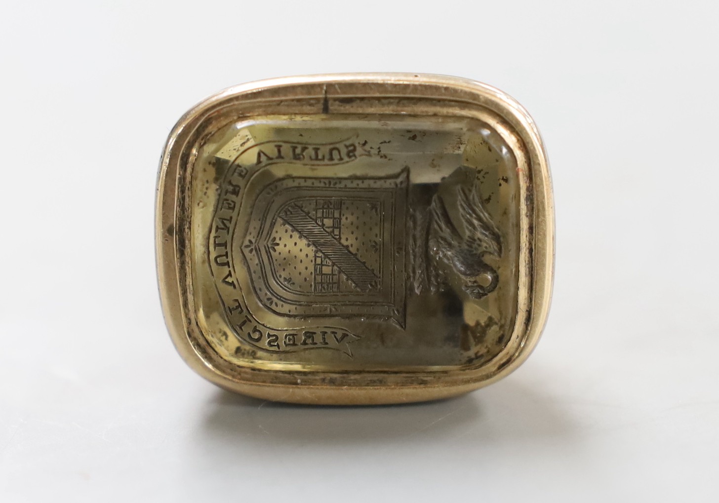 A 19th century yellow metal overlaid and citrine? set intaglio fob seal, the matrix carved with armorial and motto, 41mm.